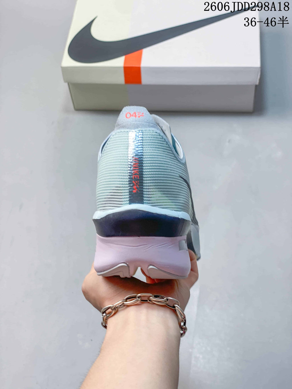 Rear view of the shoe showing the textured heel, vertical Nike detail, and sculpted heel section.