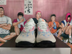 Front view of gray-blue Nike basketball shoes with white laces and pink details.