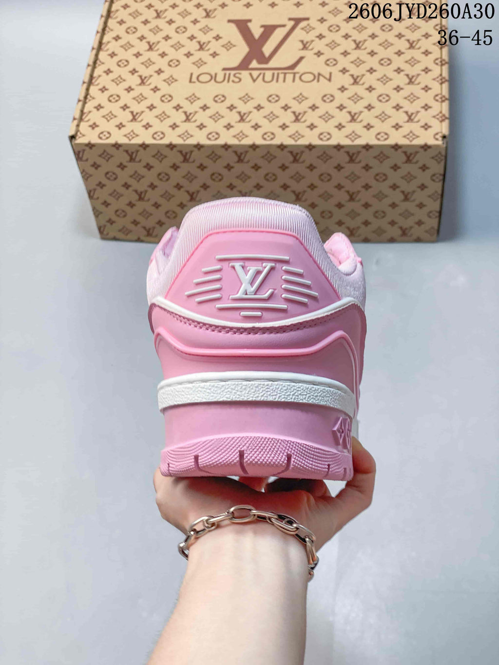 Rear view of a pink Trainer Maxi sneaker with logo detailing and a chunky sole.