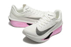 Pair of white Nike Zoom Fly 6 shoes with black swooshes and pink midsoles