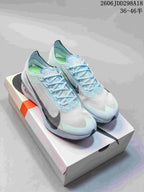 Pair of pale blue and white Nike ZoomX Vaporfly NEXT% 4 shoes displayed on a Nike shoebox; the image shows the size range marking 36–46.