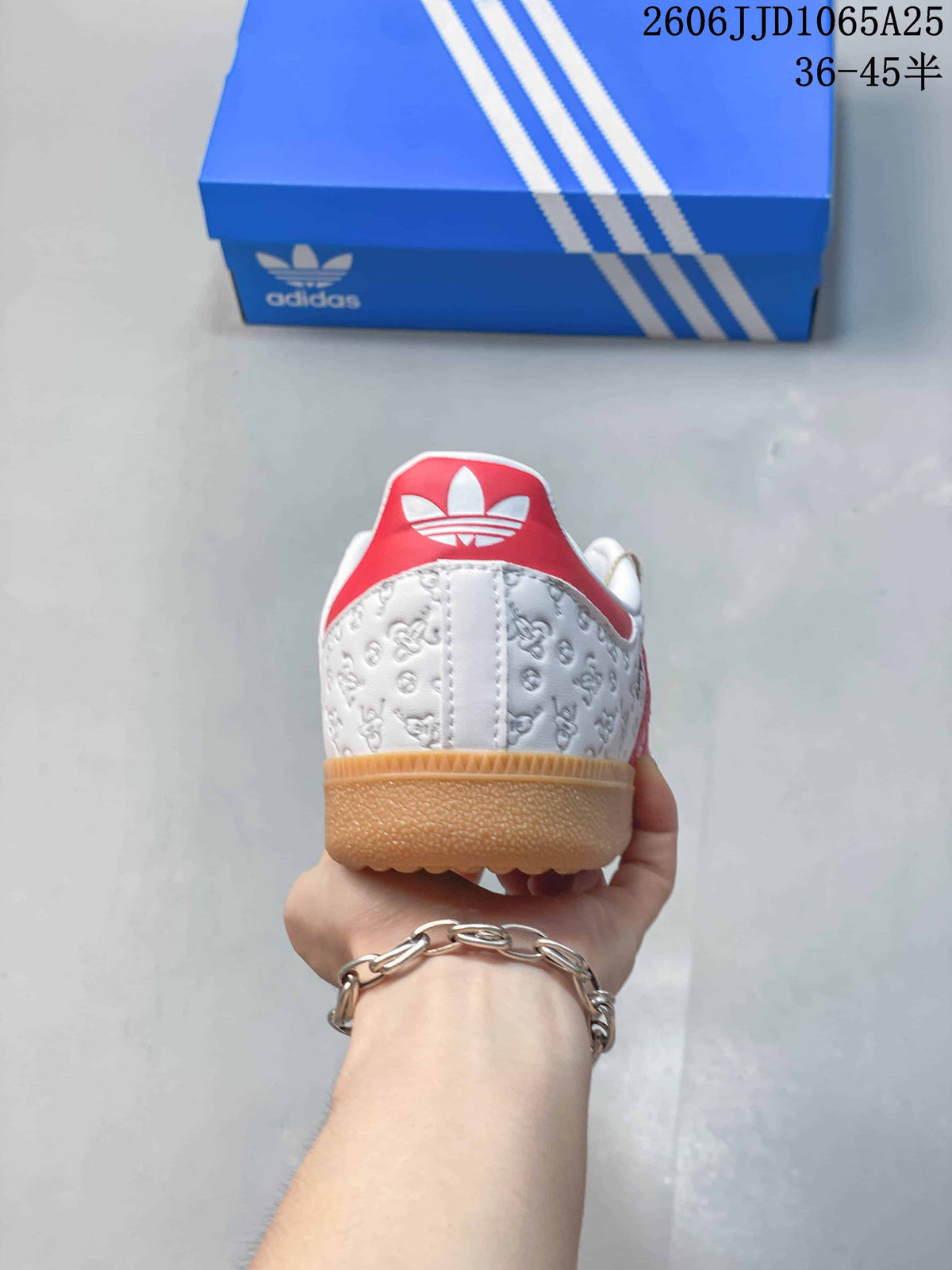 Rear view showing the white embossed upper, red heel accent, gum outsole, and Adidas trefoil shoebox.