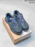 Pair of dark navy On Cloudnova sneakers displayed on a shoebox, showing the lace-up upper, padded collars and tonal outsole.