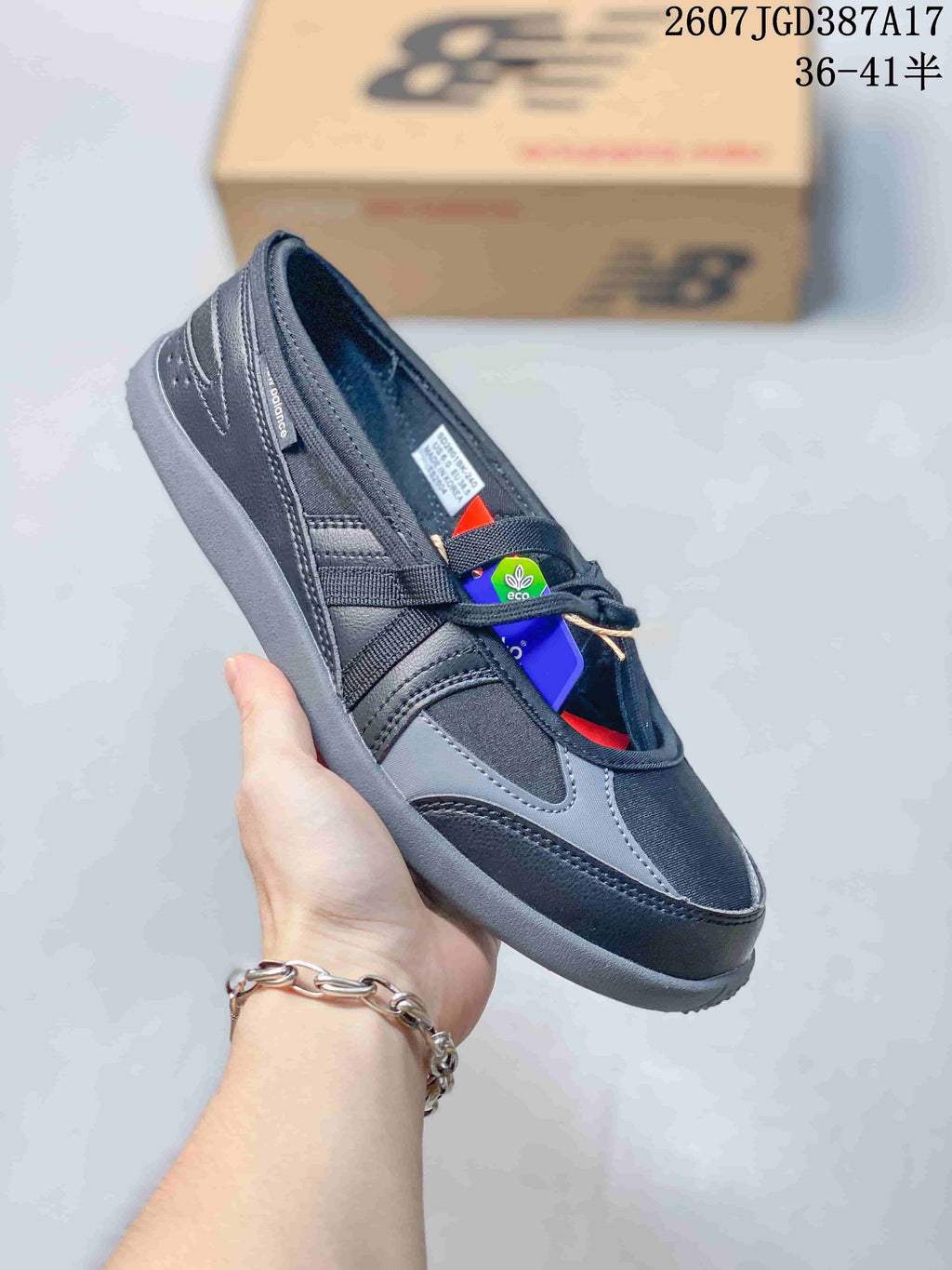 Angled side view of the black and gray sneaker with its low-profile outsole and visible branding.