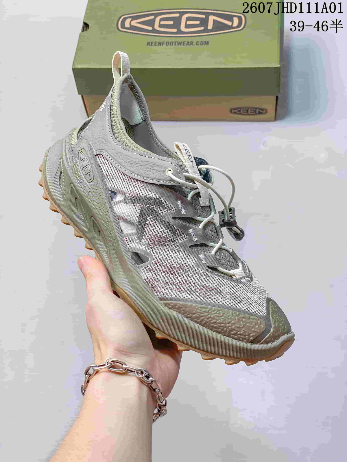 Angled side view of a gray and olive-toned KEEN Zionic ADV hiking shoe on a shoebox.