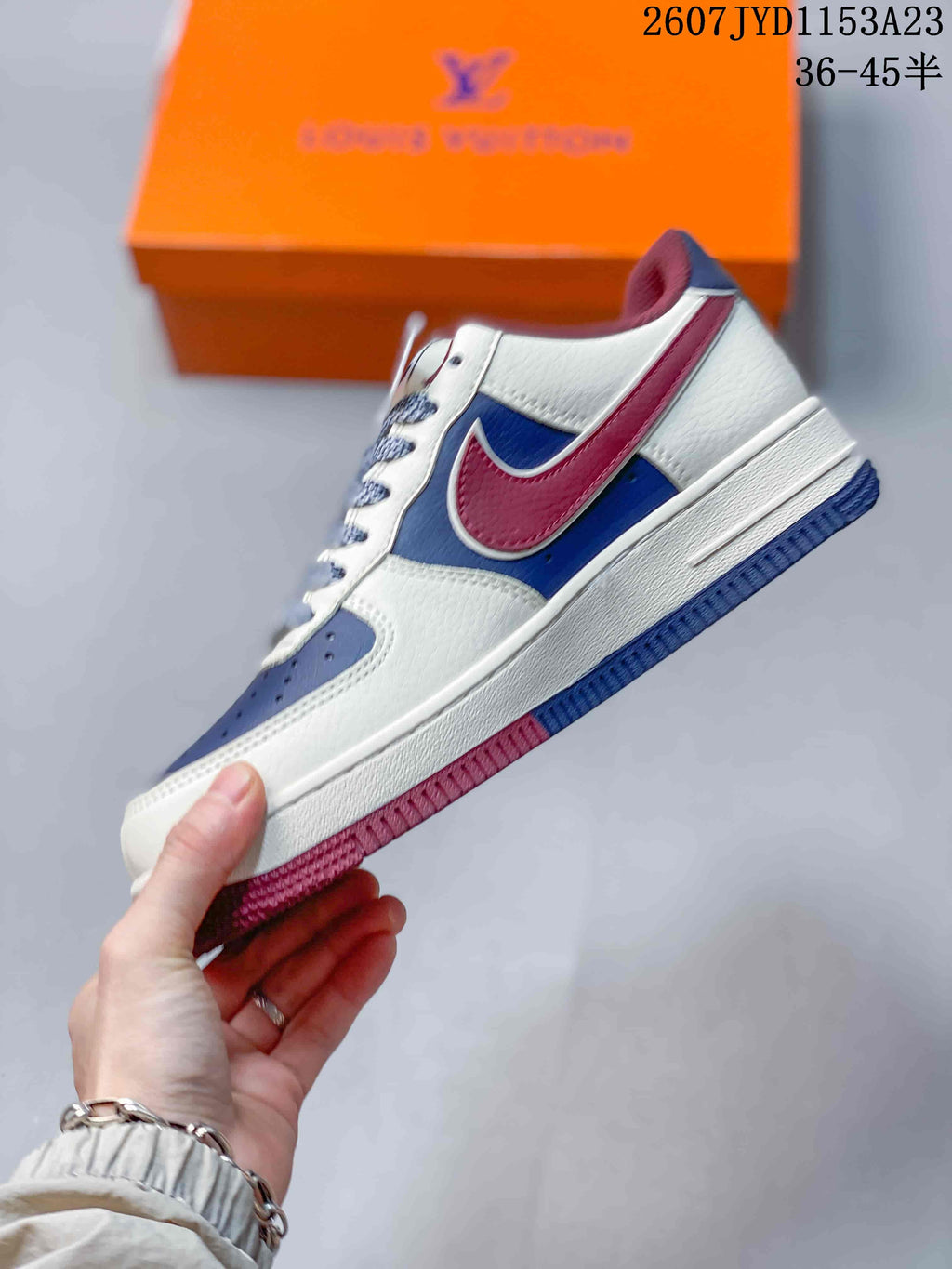 Side profile showing the white upper, blue mid-panel, burgundy Swoosh overlay and contrasting outsole.