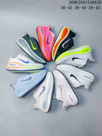 Several Nike Vomero Plus running shoes arranged in different colorways; image also shows size ranges.