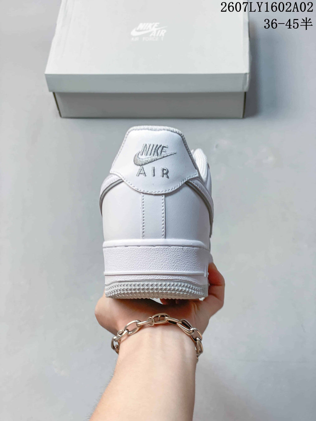 Rear view of a white sneaker showing heel branding