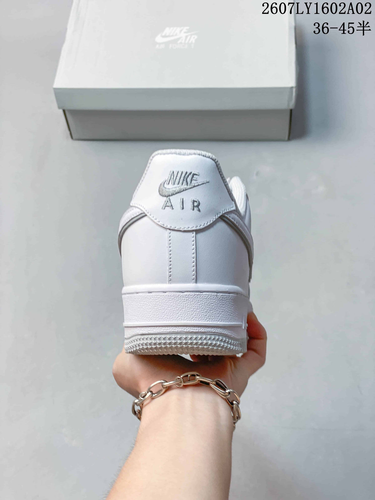 Rear view of a white sneaker showing heel branding