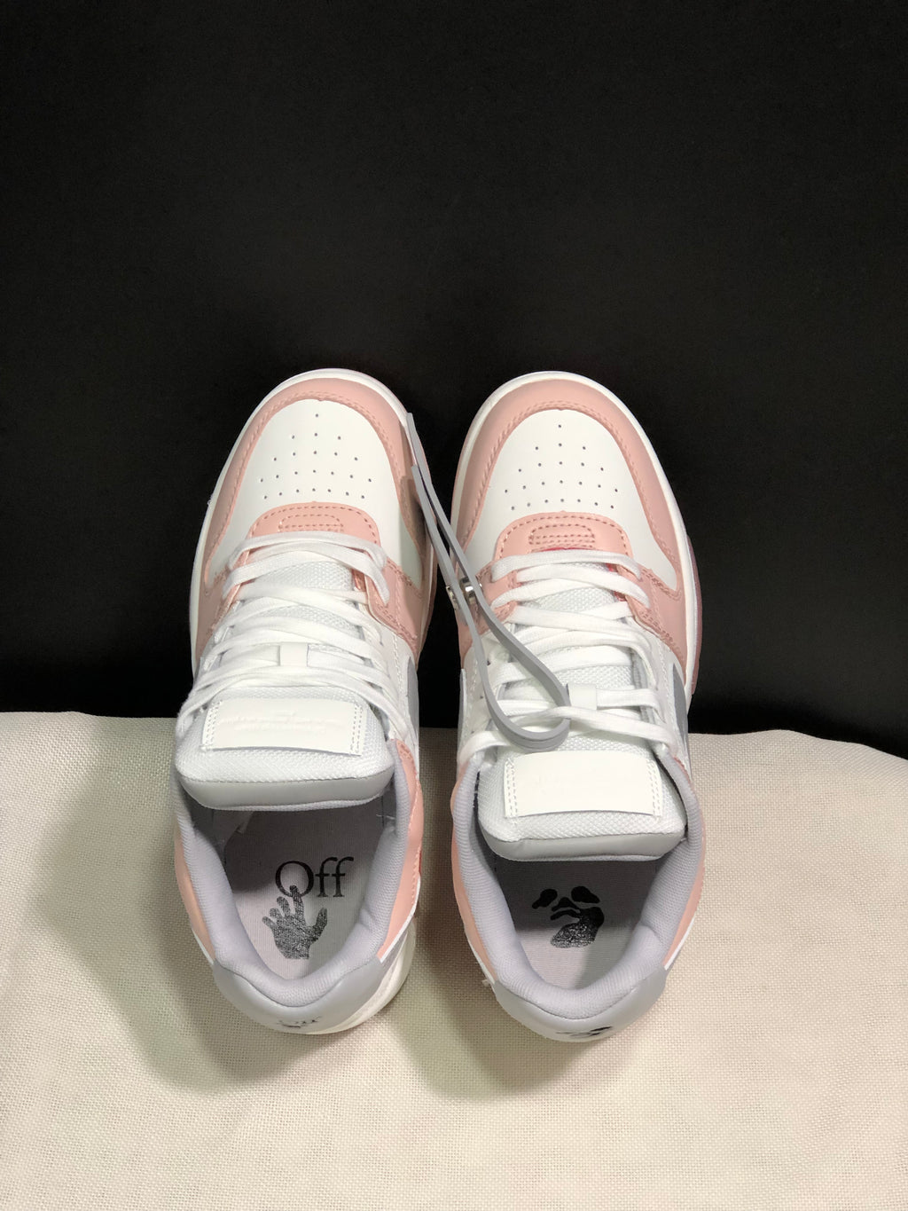 Top view of the sneaker pair showing white laces, perforated toe boxes and printed insoles.