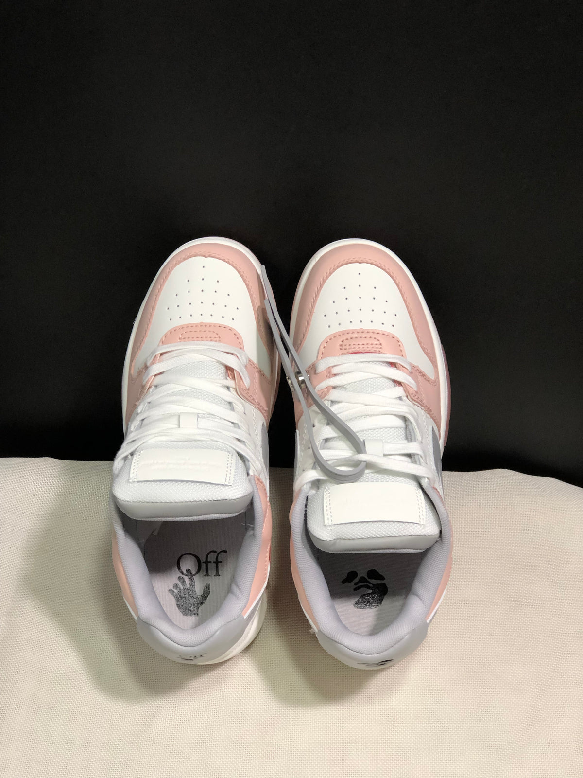 Top view of the sneaker pair showing white laces, perforated toe boxes and printed insoles.