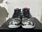 Front view of gray camouflage Nike basketball shoes with black laces, blue accents, and white soles.