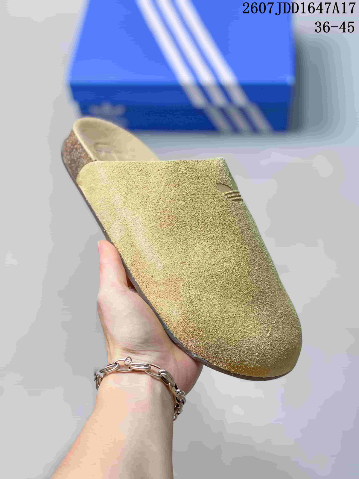 Close-up side view of a light green adidas Adimule mule slide with Trefoil branding.