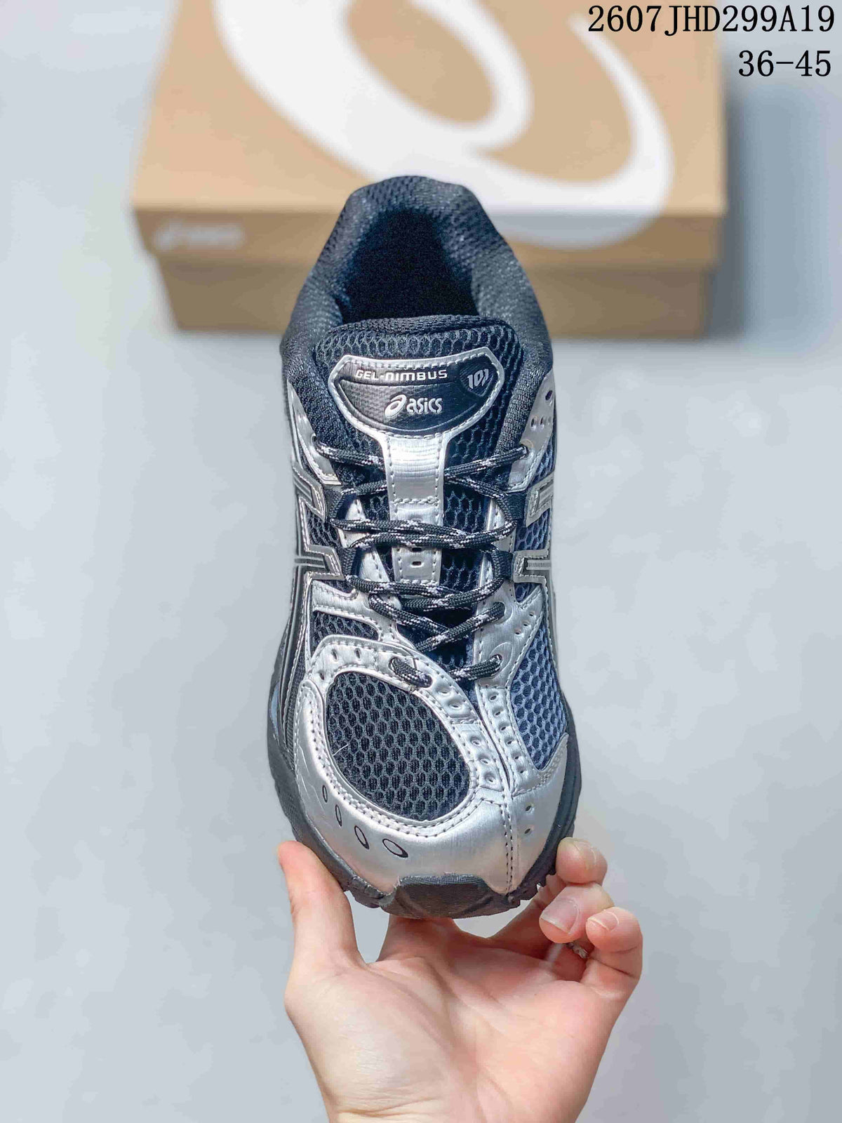 Top view of the sneaker showing the mesh toe box, silver overlays, laces, and GEL-NIMBUS tongue label.