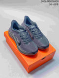 Pair of dark gray Nike Air Zoom Pegasus 42 running shoes displayed on an orange shoe box.