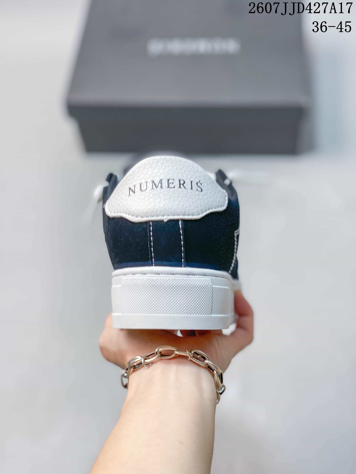 Rear view of a Numeris sneaker showing the white heel panel, navy upper, and branded heel detail.