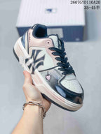 Angled side view of the sneaker showing the MLB side logo, pink and black details, and a small heart graphic.