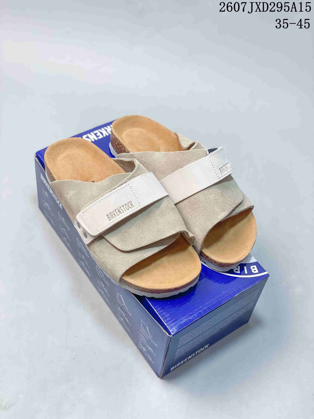 Pair of light beige Birkenstock-labeled sandals displayed on a branded shoebox; style code 2607JXD295A15 and size range 35–45 are overlaid.