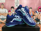 Pair of deep blue basketball shoes with aqua accents and graphic upper detailing