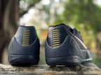 Rear view of black Kobe 9 shoes showing heel details and gold-toned accents.