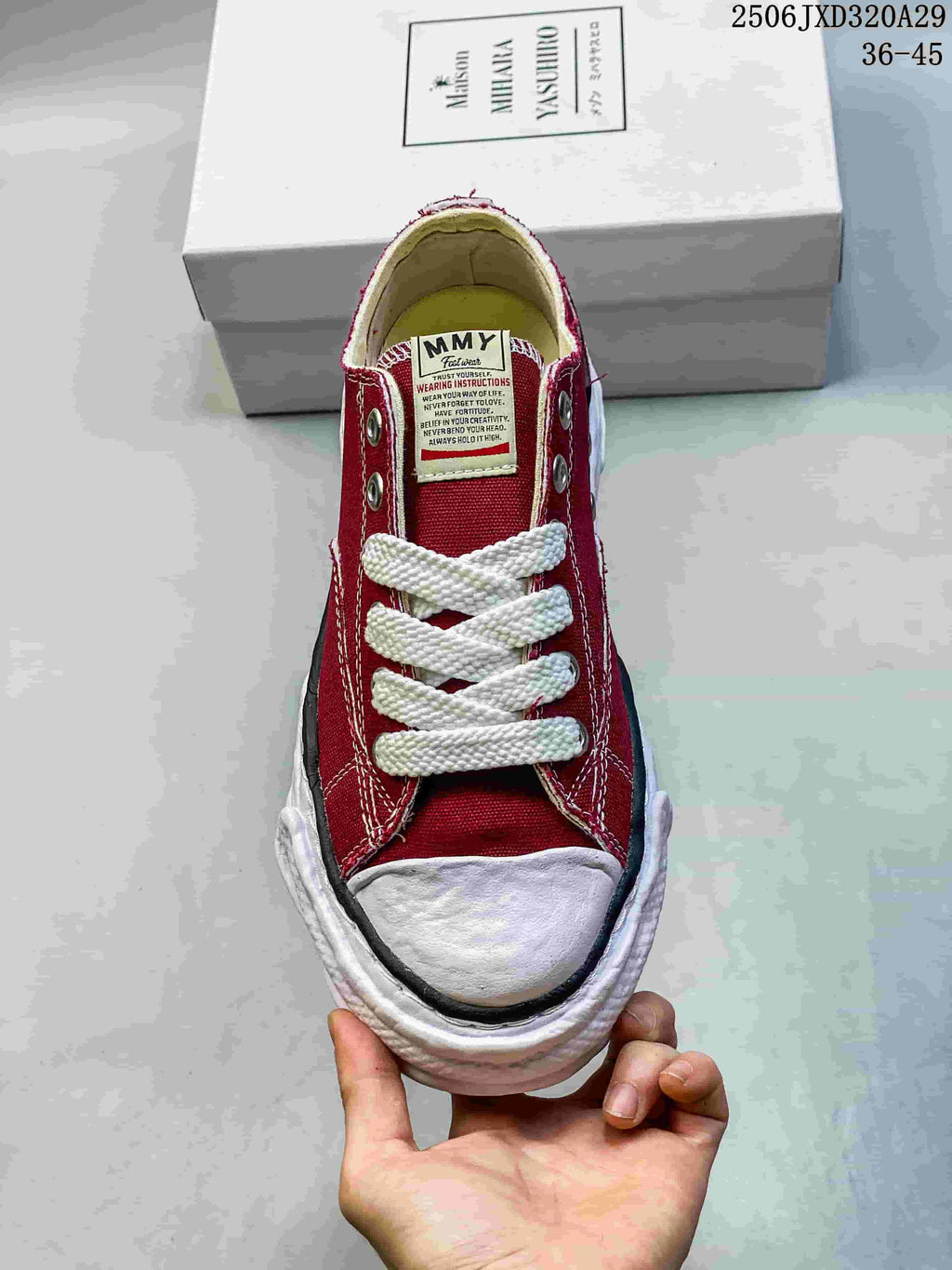Top view of a red lace-up sneaker with white laces, tongue branding and a rounded toe cap, positioned in front of a Maison MIHARA YASUHIRO shoebox; image text shows style code 2506JXD320A29 and size range 36–45.