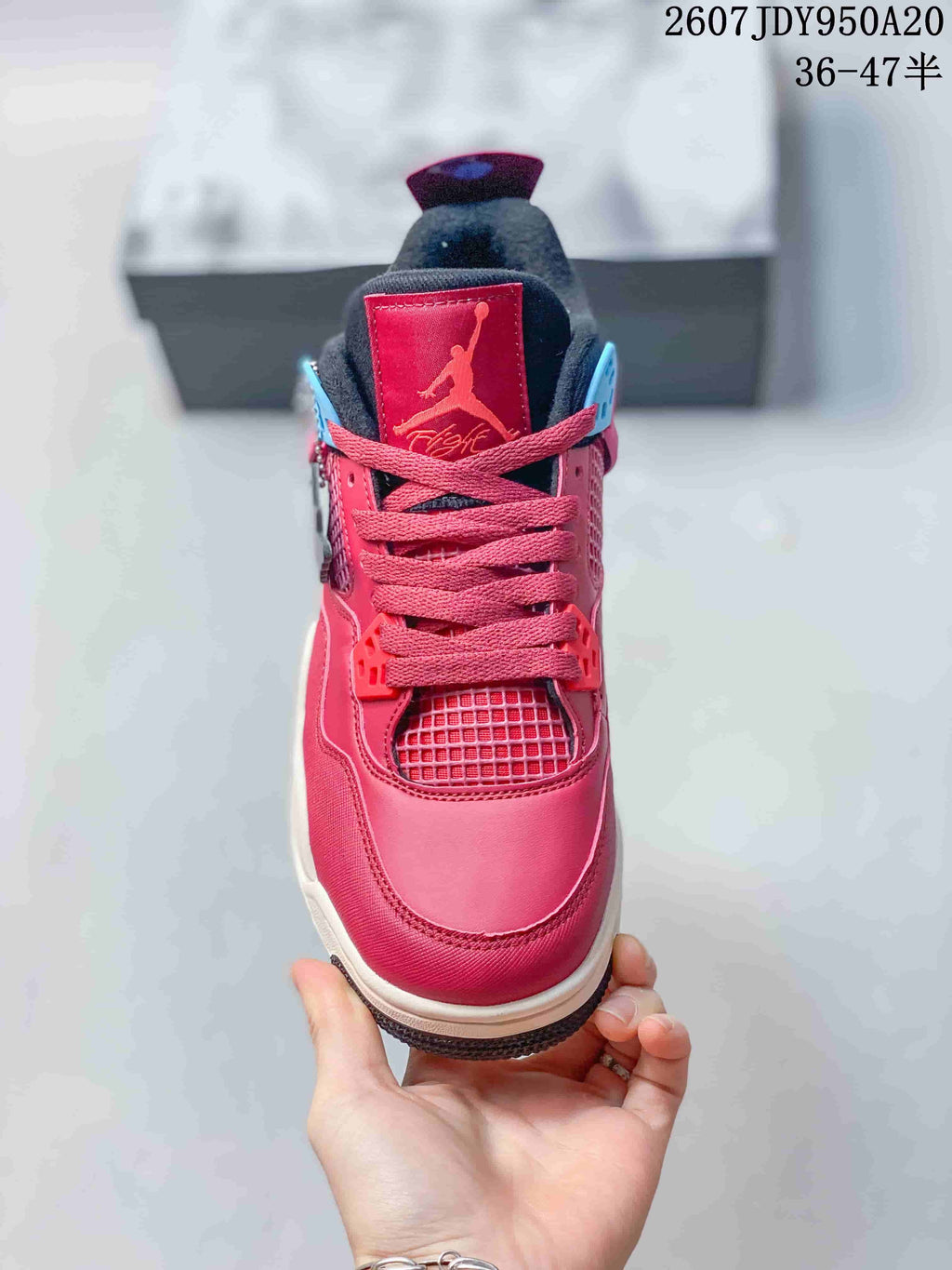 Front view showing the pink toe box, matching laces, mesh tongue area, and black padded collar.