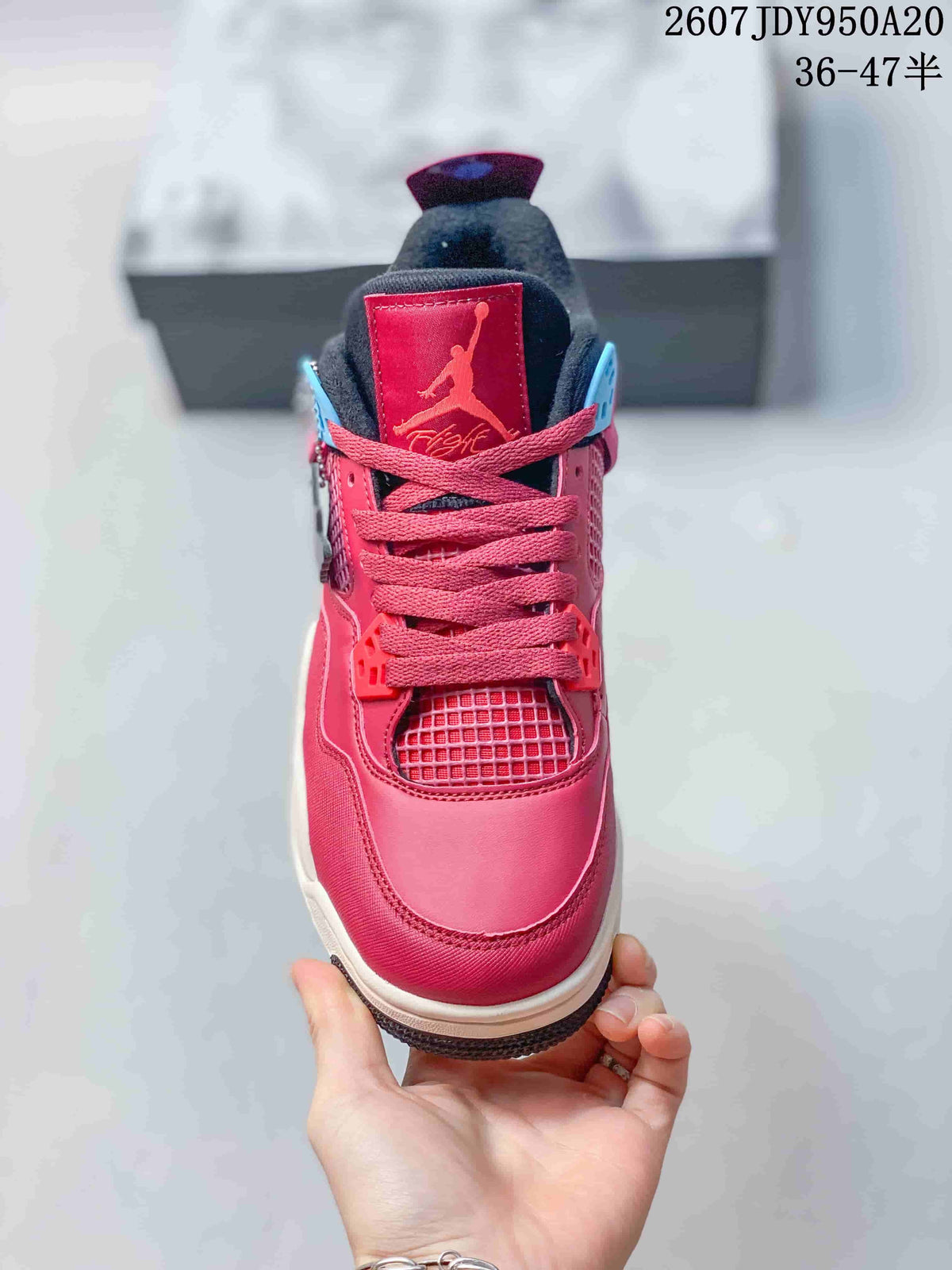 Front view showing the pink toe box, matching laces, mesh tongue area, and black padded collar.