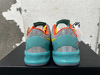 Rear view of multicolor Nike basketball shoes with turquoise heels and orange collar lining