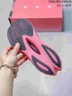 Underside of a running shoe showing the pink and dark patterned outsole