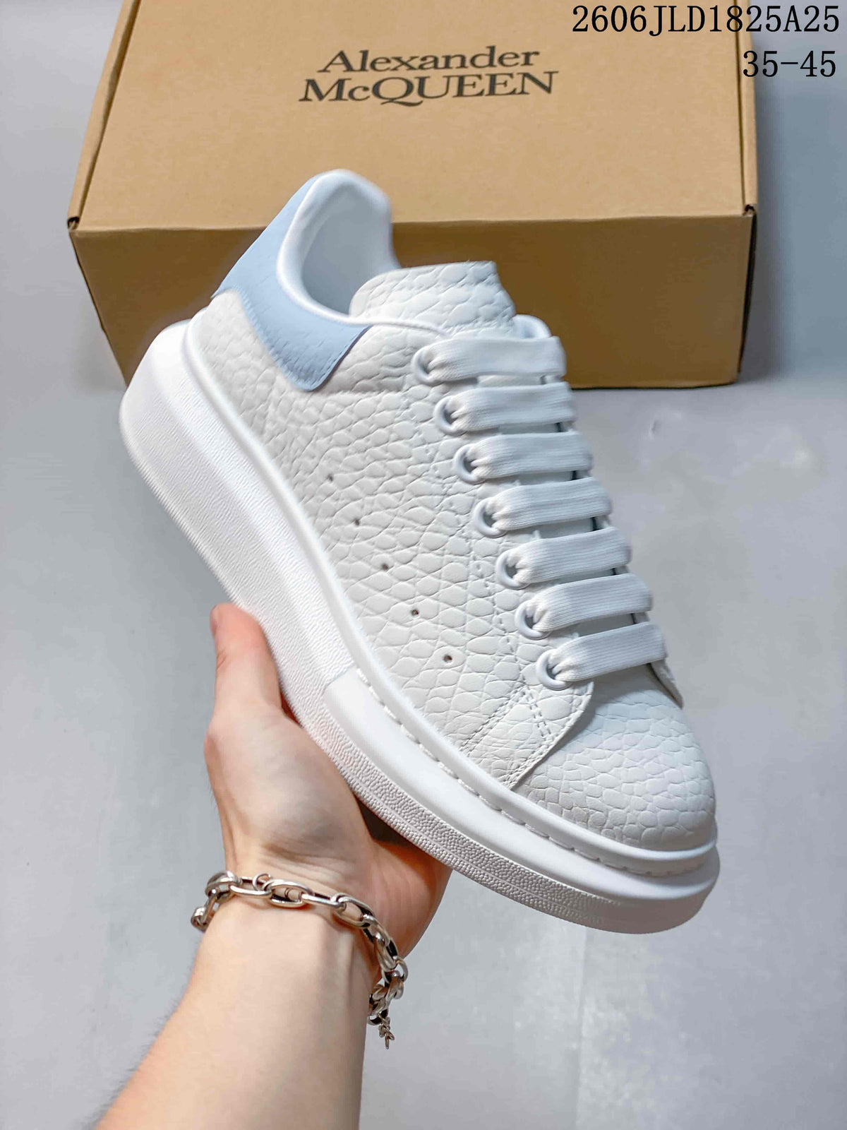 Side view of a white textured platform sneaker with a pale blue heel panel and wide laces.