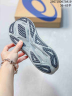 Close-up of the patterned gray and black outsole on an ASICS running sneaker.