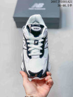 Top view of the New Balance 9060R sneaker with white laces, mesh panels, and the 9060R tongue marking.
