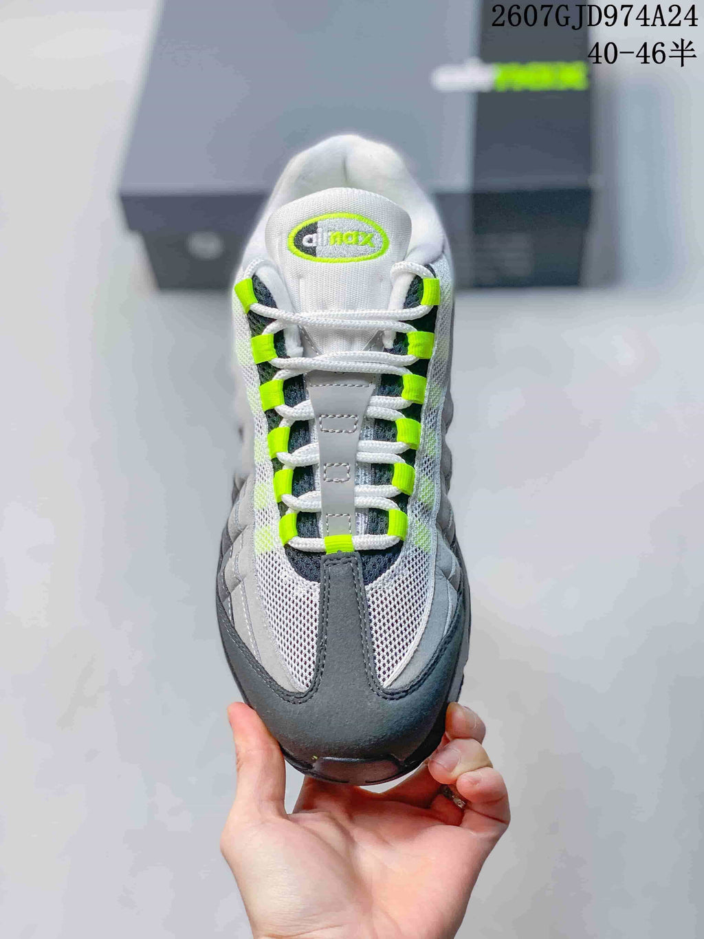 Top view showing the mesh toe box, white laces, neon green lace loops and tongue branding.