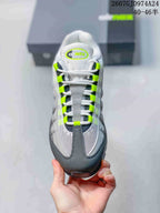Top view showing the mesh toe box, white laces, neon green lace loops and tongue branding.