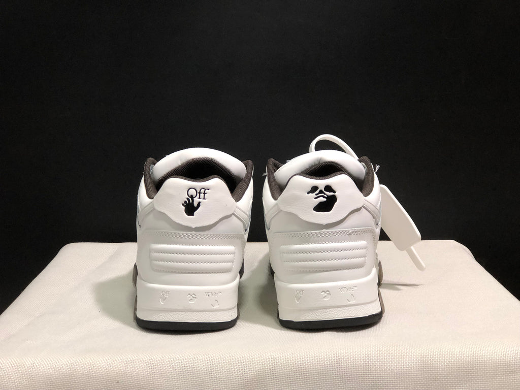 Rear view of the white sneaker pair showing padded heel sections, dark collar lining, and printed heel details.