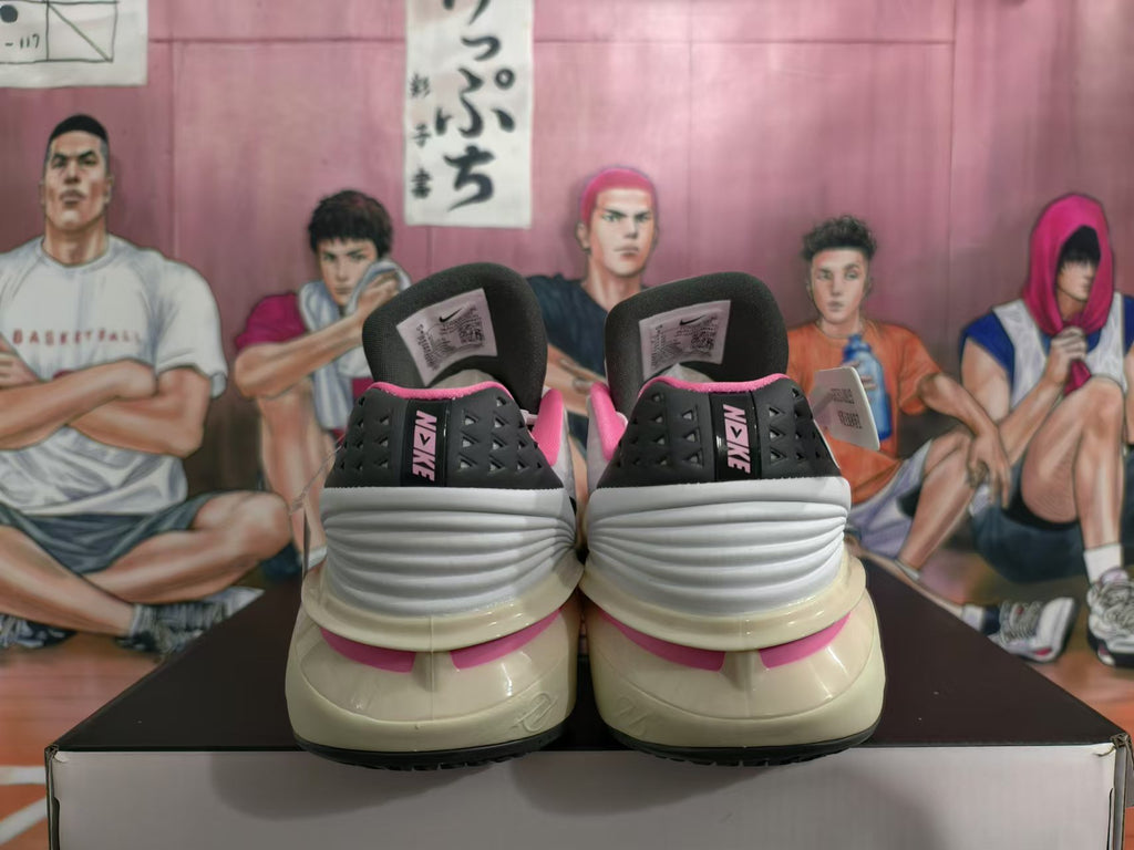 Rear view of white basketball shoes with black heel panels and pink accents