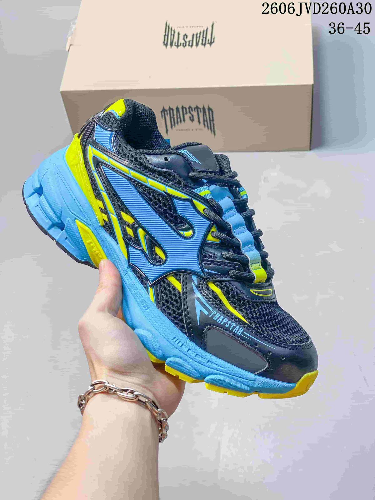 Blue, black, and neon yellow Trapstar Trispeed 3000 sneaker with a chunky sole.