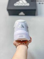 Rear view of a white adidas training shoe with the adidas logo on the heel.