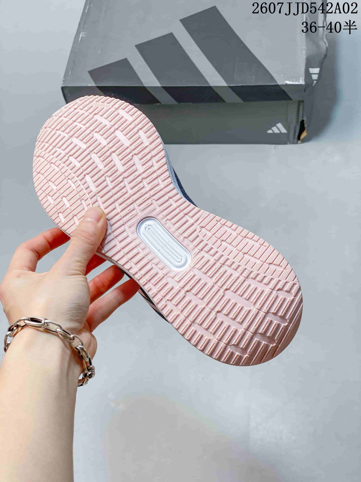 Close-up of the pink-toned outsole and tread pattern.