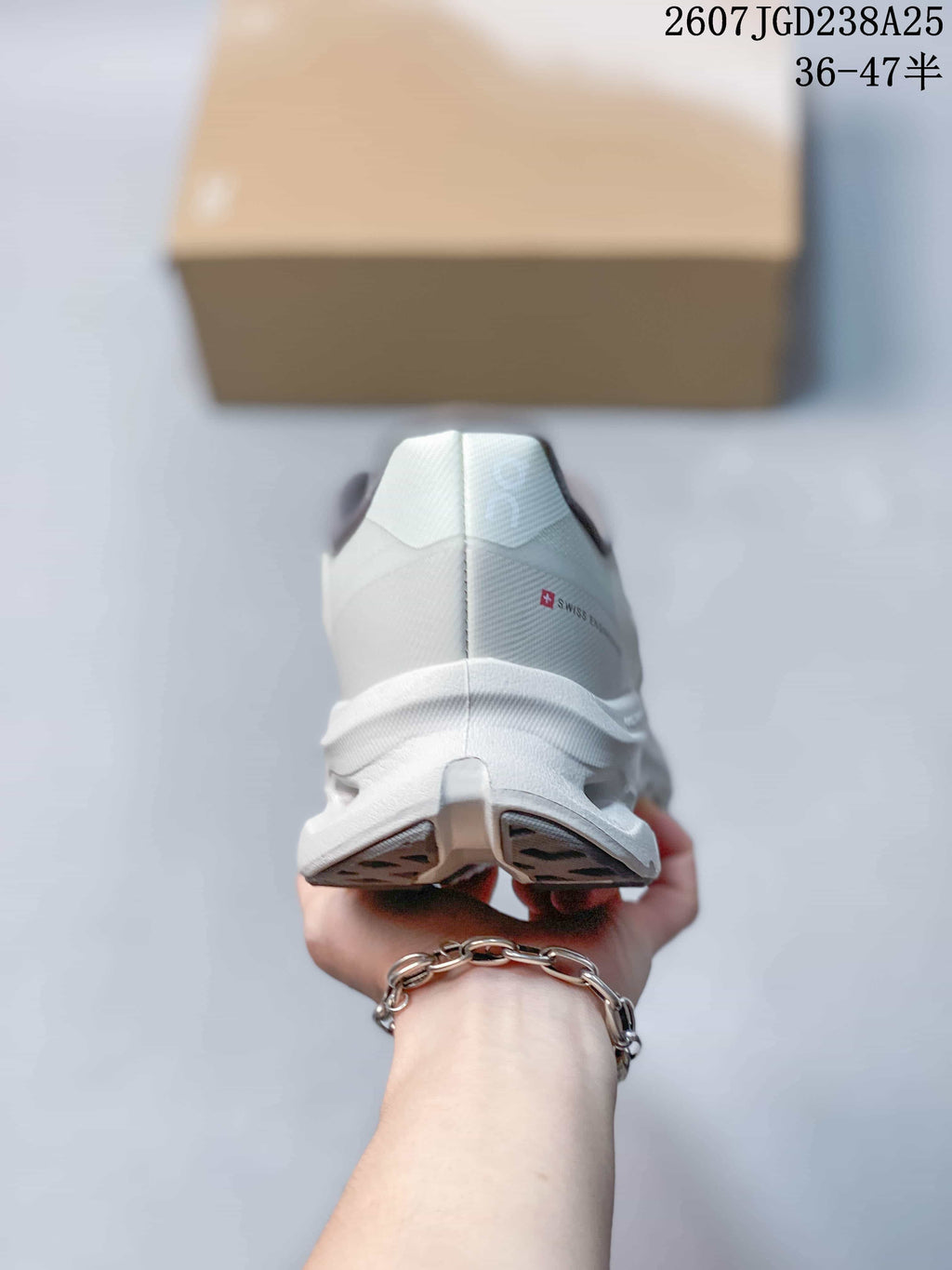 Rear view of the white and gray sneaker showing the heel structure and outsole.
