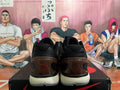 Rear view of brown and black Nike Zoom basketball shoes with dark translucent heel details and light-colored midsoles.