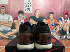 Rear view of brown and black Nike Zoom basketball shoes with dark translucent heel details and light-colored midsoles.