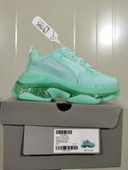 Mint green Balenciaga sneaker displayed on its box, with the side branding and box label visible.