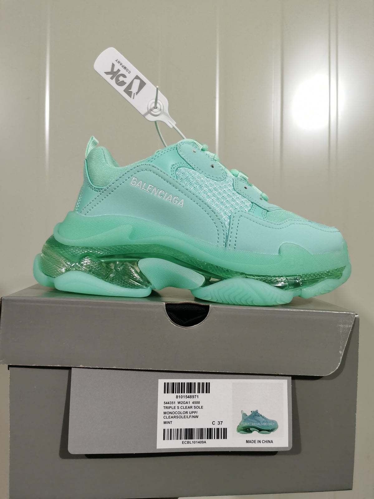 Mint green Balenciaga sneaker displayed on its box, with the side branding and box label visible.