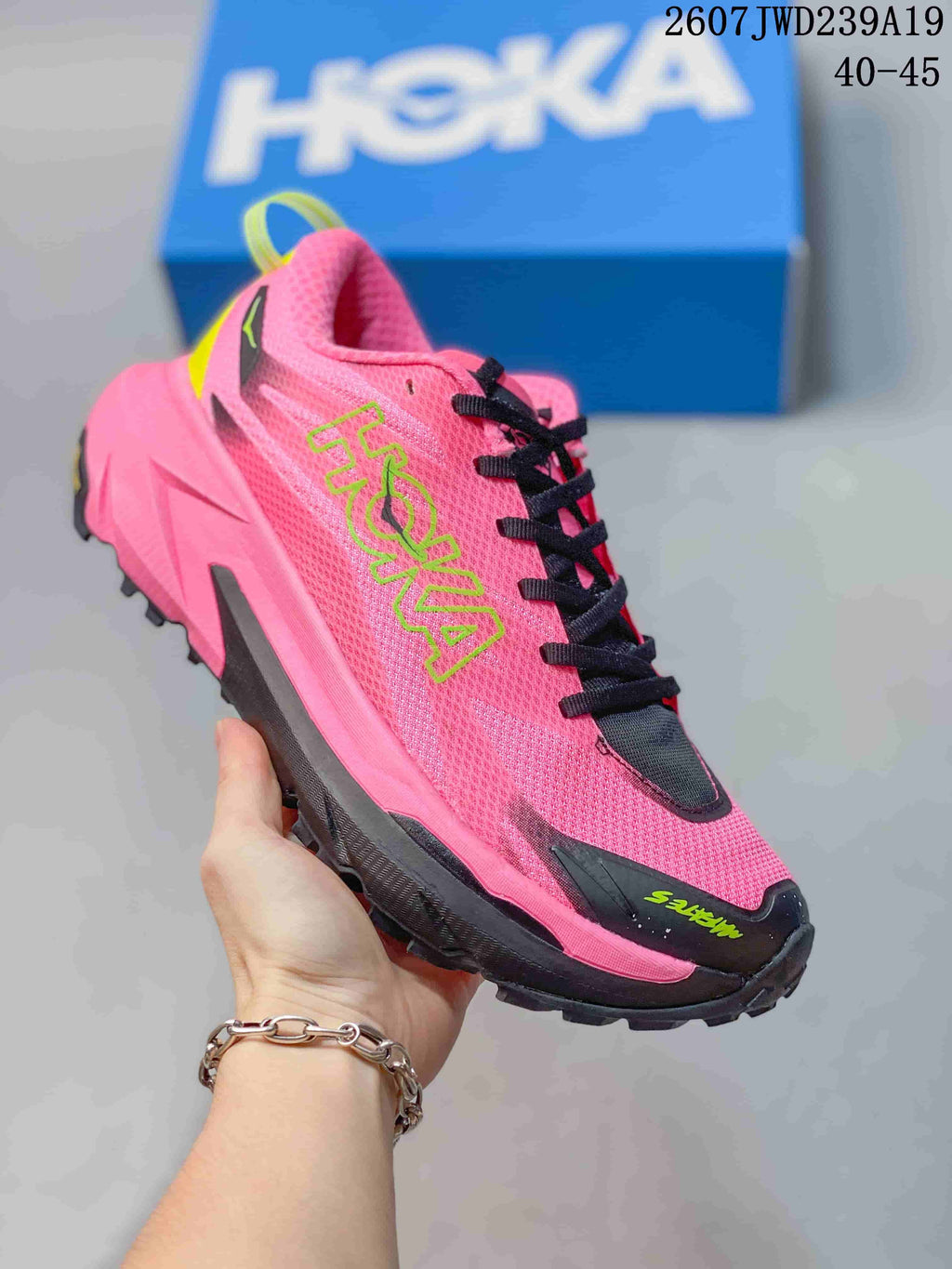 Bright pink HOKA Rocket X 3 running shoe with black details and neon green branding; image text shows code 2607JWD239A19 and sizes 40–45.