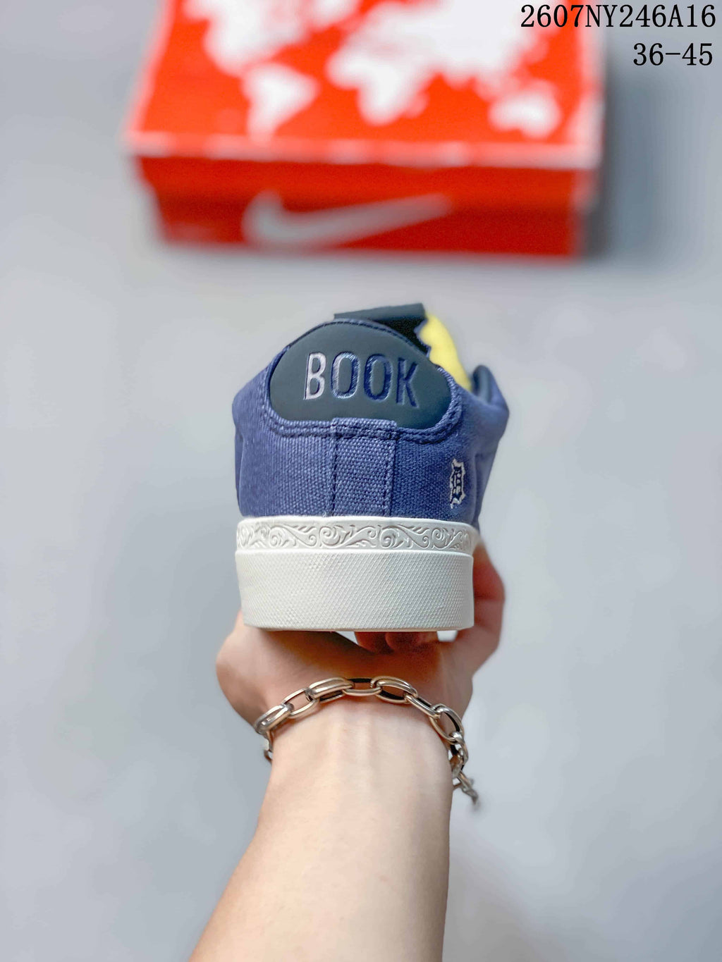 Rear view of the blue sneaker showing Booker branding on the heel and a white midsole.