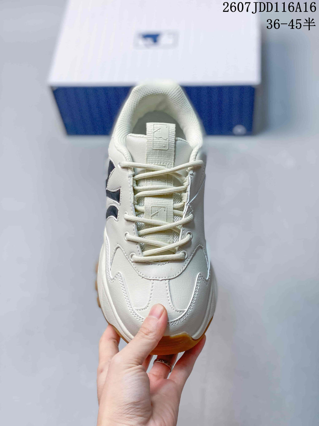 Top view of the sneaker showing the lace-up construction, tongue and layered toe panel.