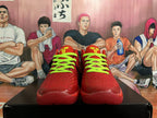 Front view of red basketball sneakers with bright green laces