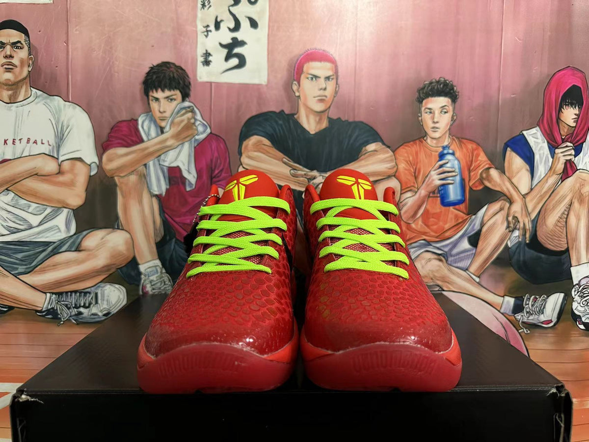 Front view of red basketball sneakers with bright green laces