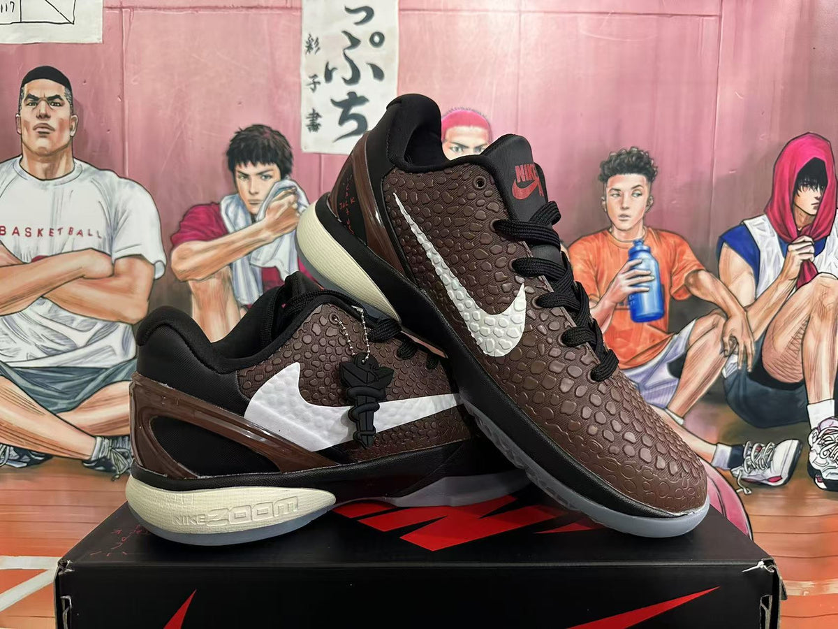 Pair of brown Nike basketball shoes displayed at an angle, showing the white Swoosh, textured upper, and contrasting soles.
